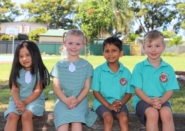 Kindergarten students sitting on a bench